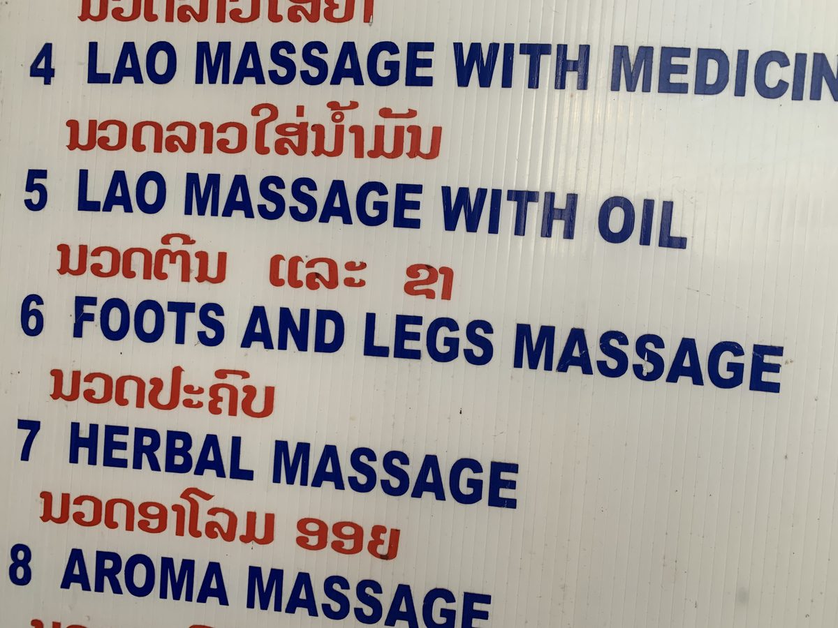Massage menu board with Lao, foot, legs, herbal and aroma massage options